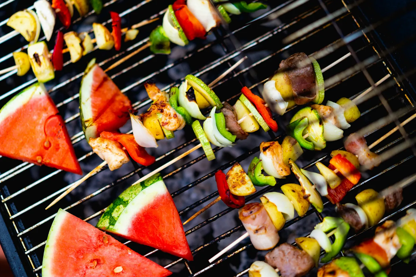 Illustrative stock photograph of colorful skewers cooking on a grill