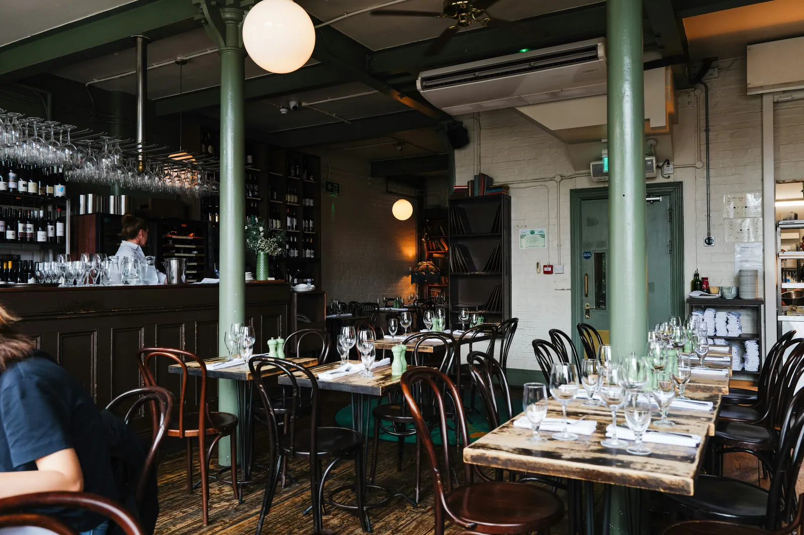 Illustrative stock photograph of a restaurant interior with dining tables and a bar area